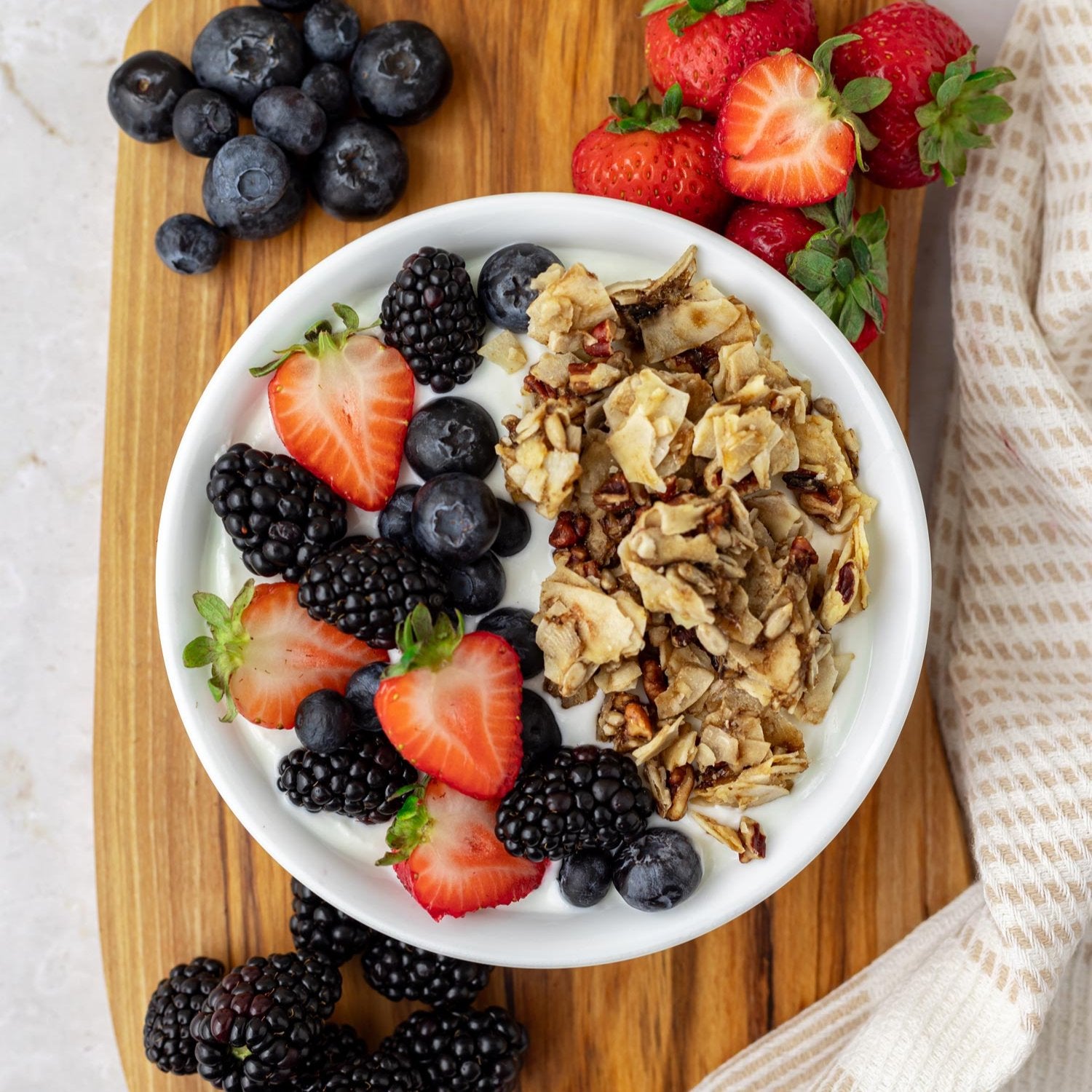 healthy Zaxsnax coconut with granola and fresh fruit on a charcuterie board