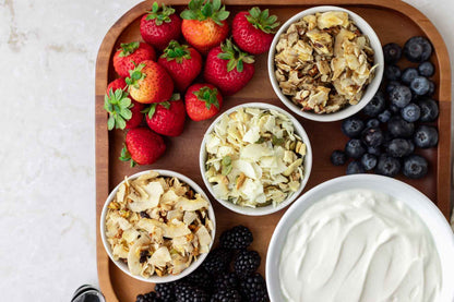 Bowls of ZaxSnax coconut snacks on a party platter with ruit and dip